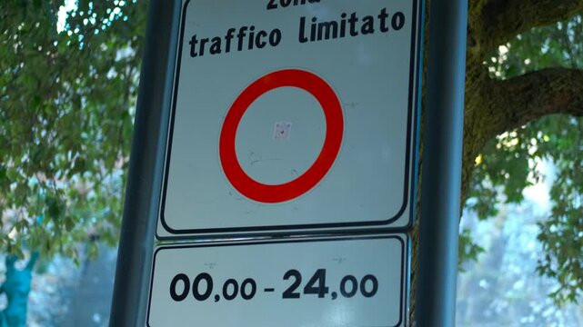 Italian limited traffic zone ztl sign activating. Electronic display of a ztl sign, zona a traffico limitato, in an italian city changing its status from closed to active, restricting access