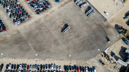 Aerial view of car storage lot with vehicles and machinery  at Copart yard, York, UK. © iSky Media