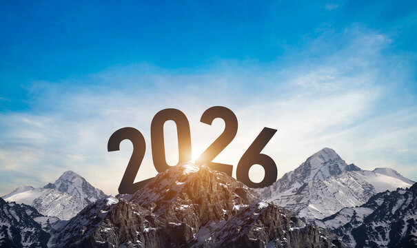 The Year 2026 on a Mountain Summit with Sunrise . A silhouette of the number 2026 against a snow-capped mountain and a blue sky, a shimmering design to celebrate the New Year. The mountain peak 
