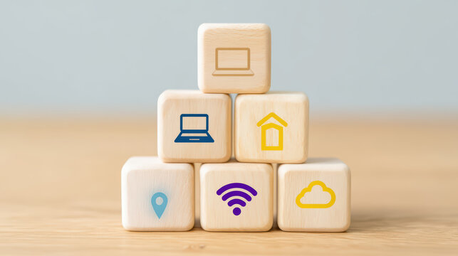 Wooden cubes arranged in pyramid shape with of laptop, location pin, wifi signal, cloud, and house symbolizing technology and connectivity concepts in soft natural light