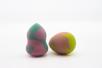 Multicolored beauty blenders. Two sponges for applying makeup on white background