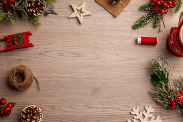 Minimal Christmas background with natural festive elements on wooden surface, ideal for website hero sections, seasonal interfaces and winter campaign layouts