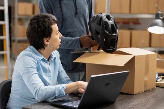 Diverse team checking order logistics for small business in house operations, small scale warehouse activity to ensure import export and distribution. Delivery service and inventory control.