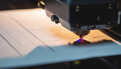 Close-up of a 3D printer head extruding material onto a flat surface, creating a precise design.