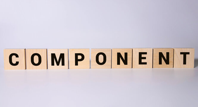 gray word component made of wooden square letters on brown background