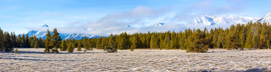 View of the Teton mountain range from the valley on a cloudy day