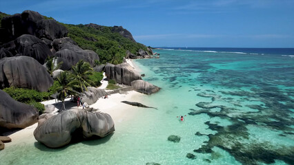 Luxury resort photo of Seychelles tropical paradise islands in Indian Ocean with palm trees, sandy beach, stones. Beautiful photography, coral reef, azure ocean,  sky with clouds on horizon.  © TKalinovskaya
