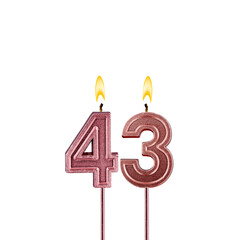 Candle number 43 - Lit birthday candle on white background