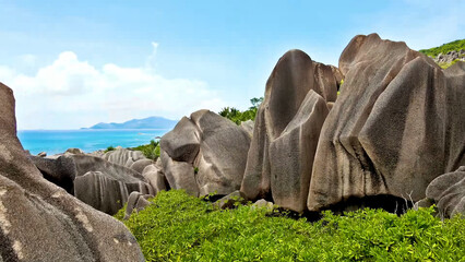 Luxury resort photo of Seychelles tropical paradise islands
in Indian Ocean with palm trees, sandy beach, stones.
Beautiful photography, coral reef, azure ocean, 
sky with clouds on horizon. 