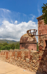 Exterior view of Castelldefels Castle, a 10th-century fortress on a sunny summer day