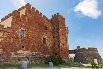 Exterior view of Castelldefels Castle, a 10th-century fortress on a sunny summer day