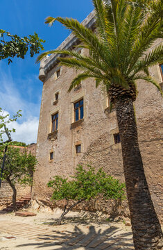 Exterior view of Castelldefels Castle, a 10th-century fortress on a sunny summer day