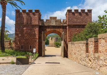 Exterior view of Castelldefels Castle, a 10th-century fortress on a sunny summer day
