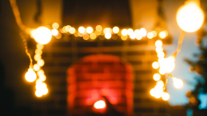 Christmas Lights Hanging Swinging Next to a Lit Fireplace in a Room at Night