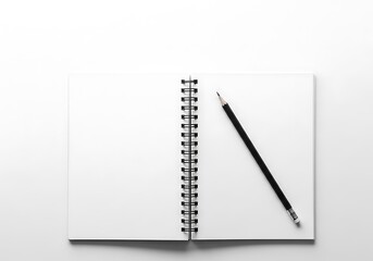 Open spiral notebook with black pen on white background