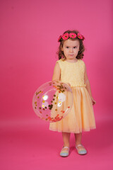Little girl celebrating birthday holding confetti balloon