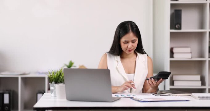 Businesswoman working at office with documents on his desk, doing planning analyzing the financial report, business plan investment, finance analysis concept	