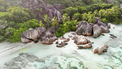Luxury resort photo of Seychelles tropical paradise islands
in Indian Ocean with palm trees, sandy beach, stones.
Beautiful photography, coral reef, azure ocean.  