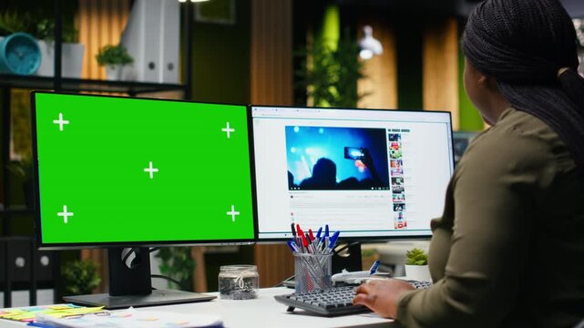 Chroma key next to production specialist checks social media platforms for reels content, boosting marketing and branding. Aligning with current media trends and monetization insights. Camera B.