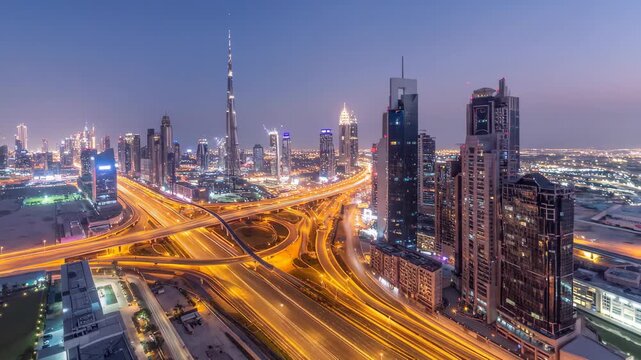 Stunning aerial view of Dubais bustling city skyline at dusk with illuminated highways and towering skyscrapers.