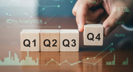 Q4 business year end review 2026 2025 new year in modern office scene showing wooden blocks labeled Q1 Q2 Q3 Q4 with analytics chart overlay indicating planning and transition