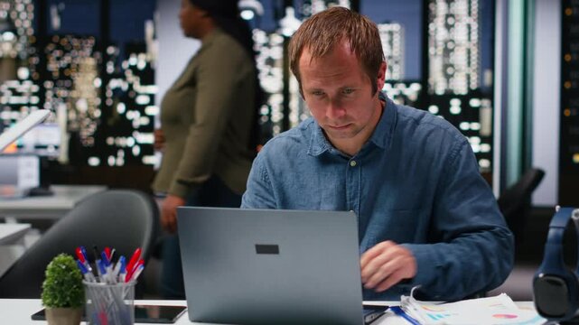 Startup employee consulting on a new corporate project with charts and files in the workspace, staff aligning targets with performance metrics for resource allocation and reports. Camera B.