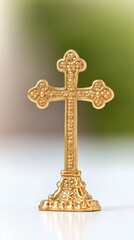 Golden Christian Cross with Intricate Details on Bright White Surface with Green Background