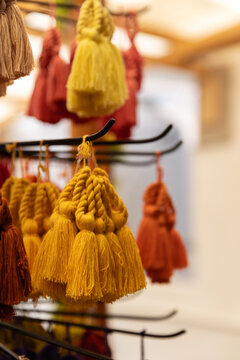 Orange and yellow colored tassel keychains at artisanal shop in Guatemala