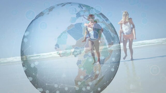 Couple walking toward lens on wet sand, globe appearing causing adults lifting children for travel - Powered by Adobe