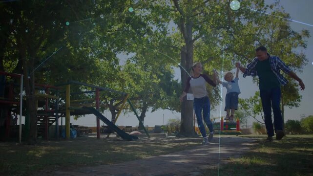 Mother and father stepping forward, lifting son, animated light flares accent playset for health ad
