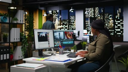 Woman video creator working on editing a movie montage project, multitasking with dual monitors. Female footage editor starting the cinematic creative process, film editing industry. Camera A.