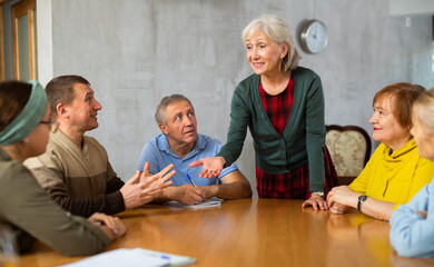 Communication of elderly at the round table. Training and group therapy with a psychologist