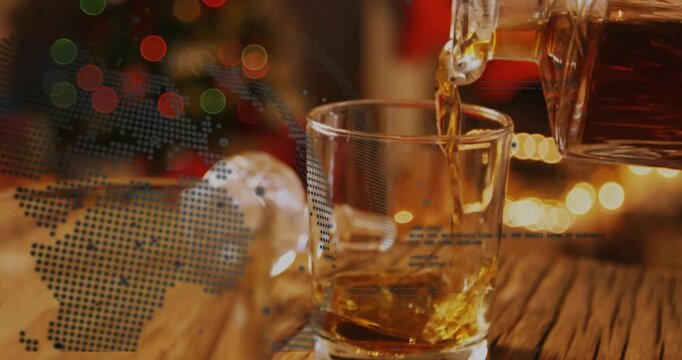 Decanter tilting pouring, tumbler filling with amber liquid swirling settling showing dotted globe