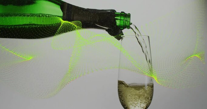 Tilting green bottle pouring into flute while neon green wave sweeping, showing bubbles rising