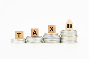 Property Tax Concept with Wooden Blocks and Coins