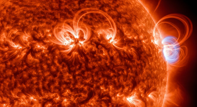 Dramatic close-up of the sun reveals intense solar flares and plasma loops emanating from its surface, showcasing the dynamic and fiery nature of our star. The intense heat and energy are visible.