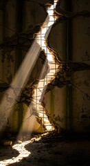 Sunlight streams through a large, jagged crack in a weathered concrete wall, illuminating the interior with warm, natural light and creating dramatic shadows on the ground