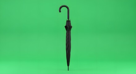 A closed black umbrella with a curved handle standing upright against a vibrant green background