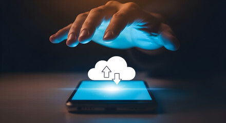 Hand hovers over a smartphone displaying a cloud icon with upload and download arrows symbolizing cloud computing data transfer and mobile technology in a modern digital environment