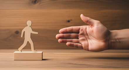 Wooden figure walking towards an open hand symbolizing opportunity and support on a wooden surface ideal for concepts like career advancement mentorship and guidance