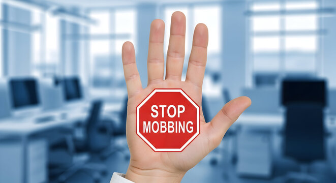 Stop mobbing sign on a hand in an office setting promoting workplace respect and ethical behavior with a clear message against bullying and harassment for a positive environment