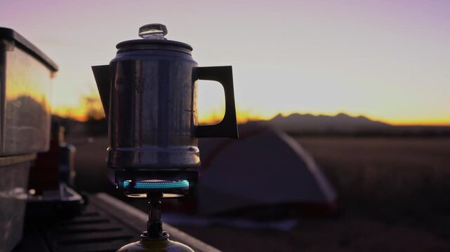 Brewing coffee at camp in the early morning