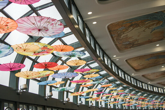 Colorful paper umbrella decorations on the room's ceiling.