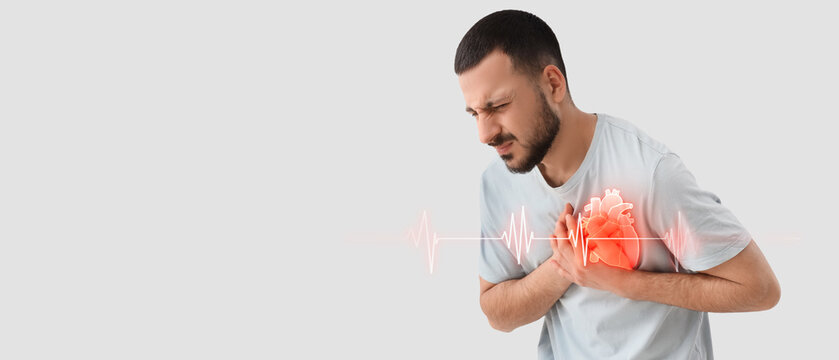 Young man suffering from chest pain on white background