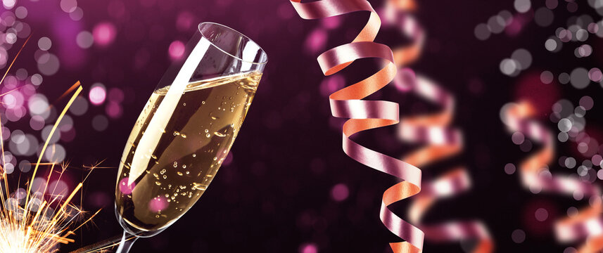Happy New Year and Merry Christmas greeting card. Glass of sparkling wine, sparkler and streamers against purple background with bokeh lights