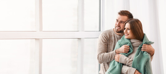 Fototapeta premium Happy couple resting near window at home