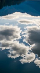 A serene landscape featuring a calm lake reflecting the cloudy sky and distant mountains under a peaceful atmosphere