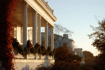 closeup view of american house beautifully adorned with garlands and wreaths on porch