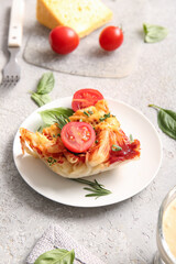 Plate of pasta with tomato sauce and cheese on grey background