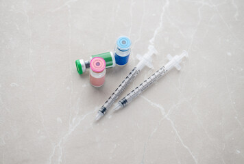 Single Use Syringes Next to Small HRT or Peptide Vials